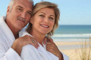 Senior couple wearing white at the beach